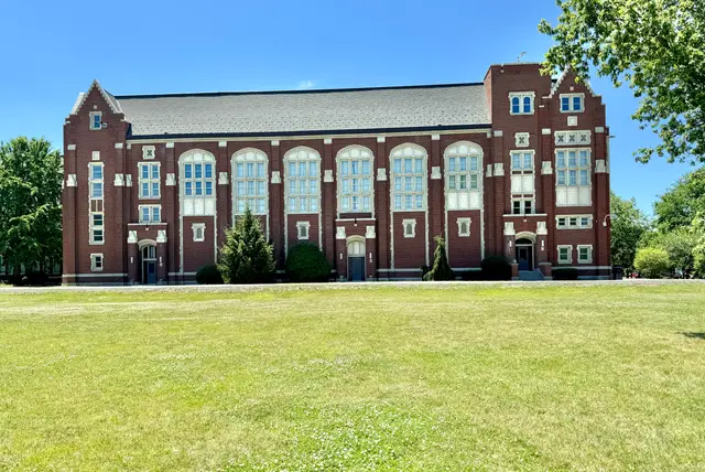 The Collegiate Gothic main building of Lane Tech College Prep seen across its front lawn