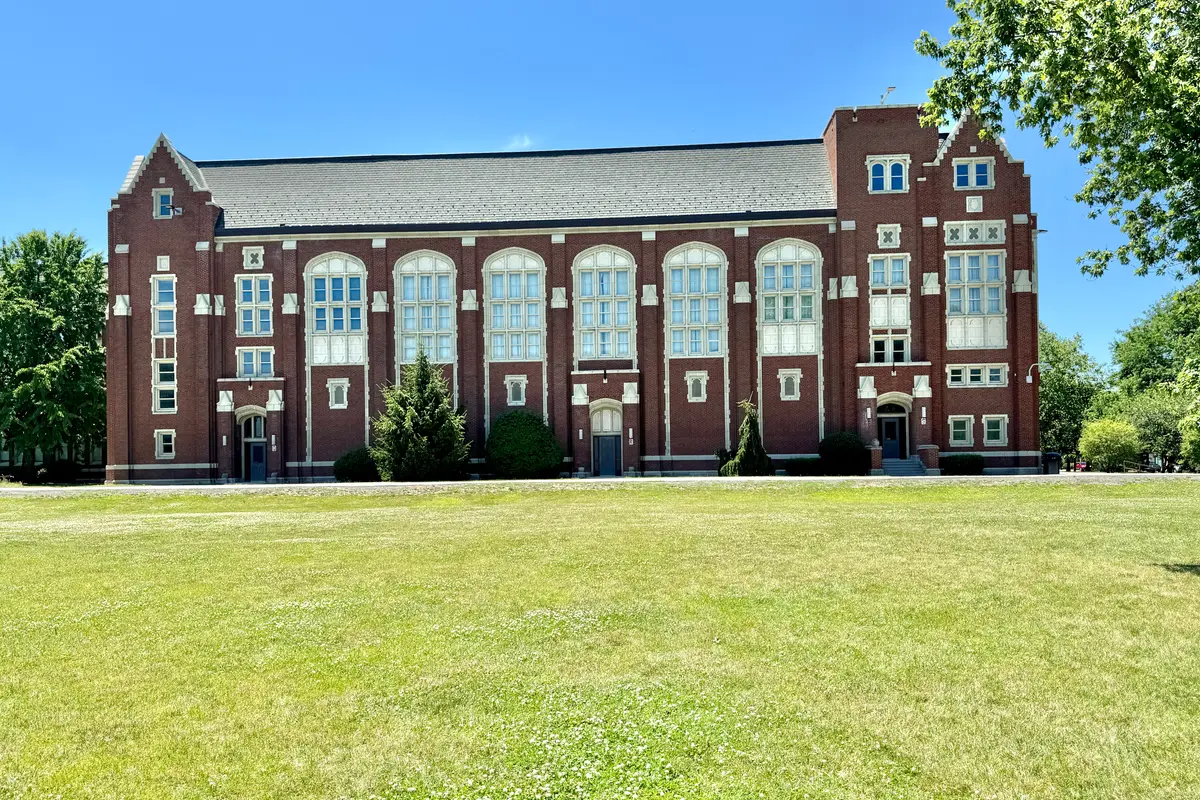 The Collegiate Gothic main building of Lane Tech College Prep seen across its front lawn
